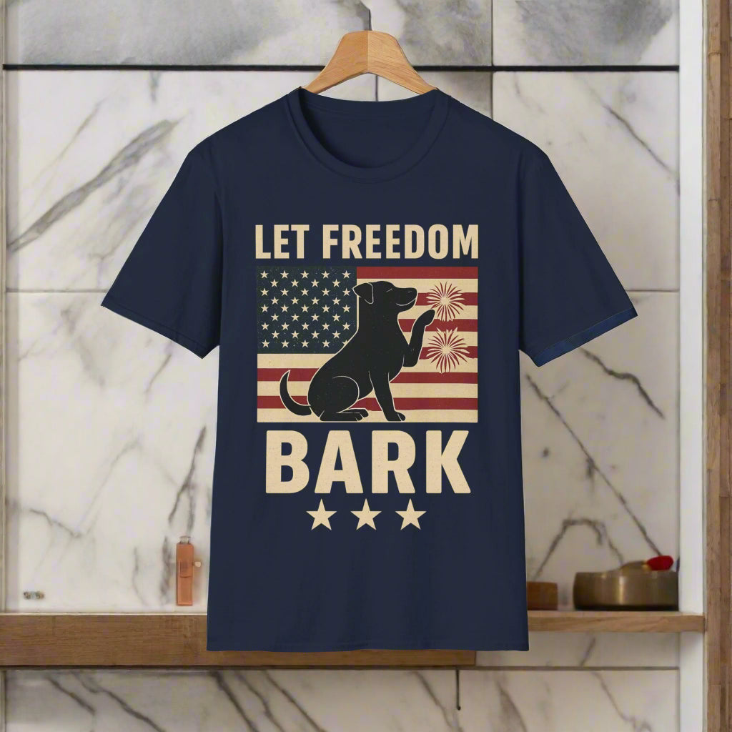 Navy Let Freedom Bark t-shirt on hanger with vintage-style patriotic design, displayed against a marble and wood bathroom wall for a clean, modern lifestyle look.
