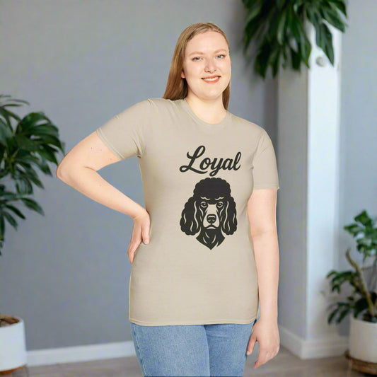 Person wearing a neutral unisex t-shirt with a bold line-art poodle face design and the word “LOYAL” in all caps below it.