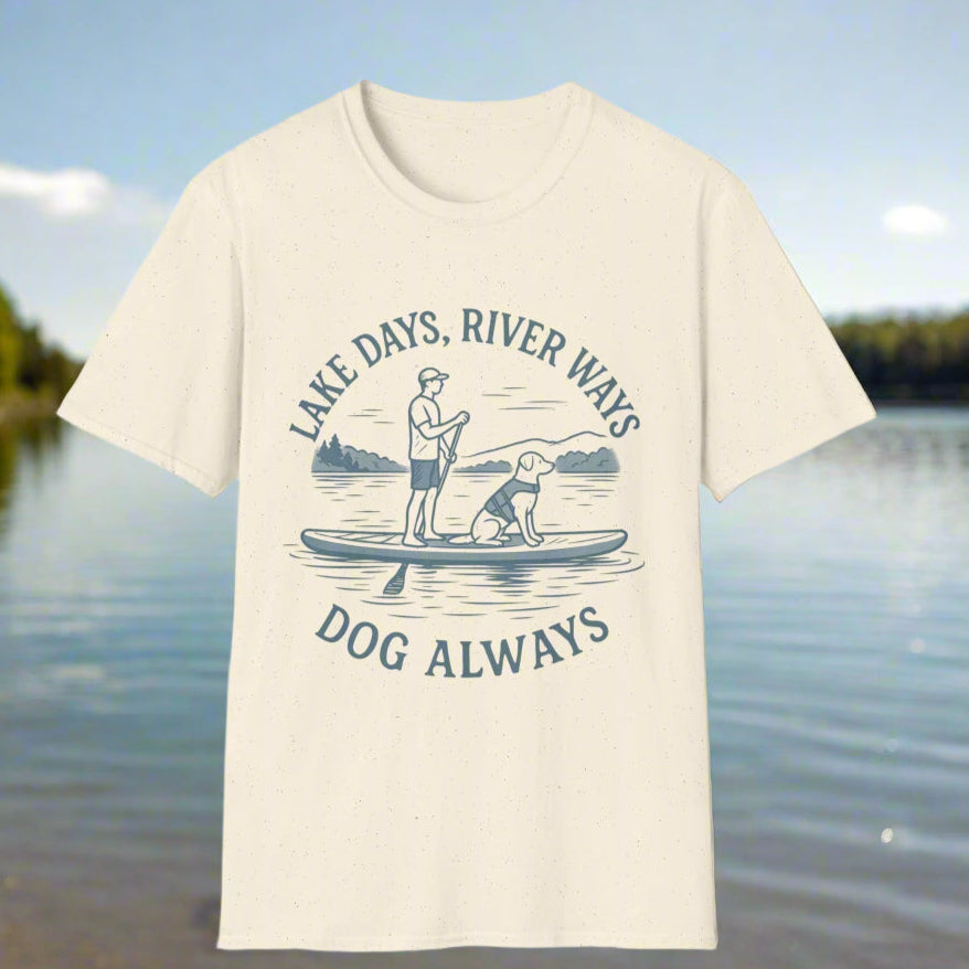 Scenic lake paddleboarding t-shirt with a rescue dog and human in a calm cove, featuring the slogan “Lake Days, River Ways, Dog Always” in faded slate blue.