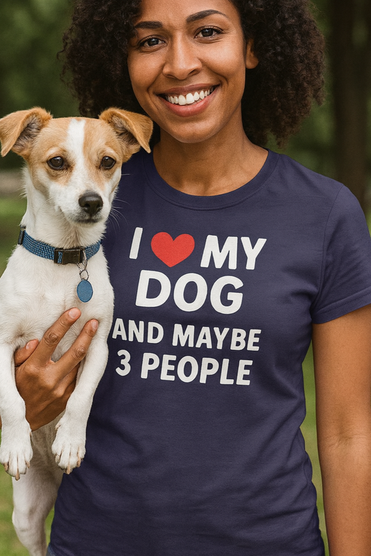 Woman holding a dog and wearing a t-shirt with 'I love my dog and maybe 3 people' text outdoors.