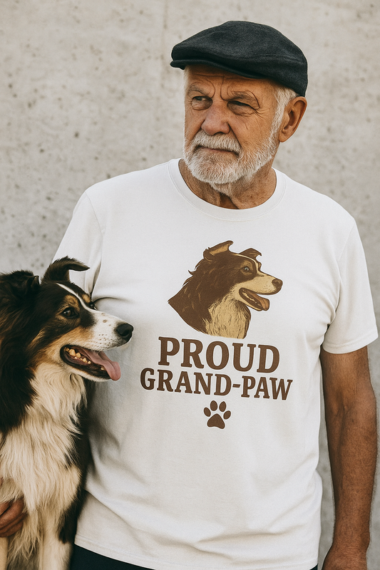 White t-shirt featuring a brown vintage-style illustration of a Border Collie head above bold text that reads “Proud Grand-Paw” with a paw print below.